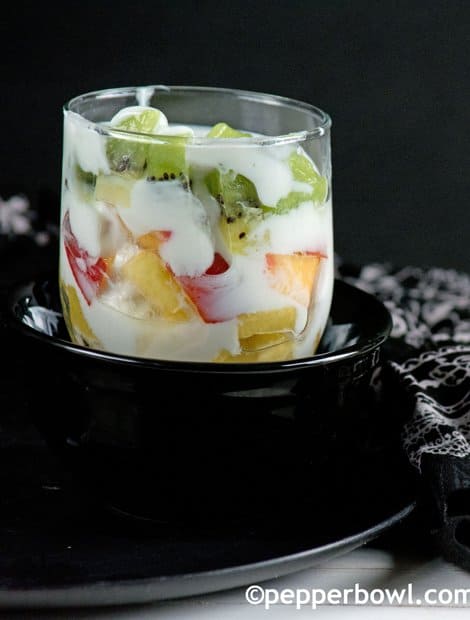Yogurt Fruit Salad served  in a clear glass for having as snack.