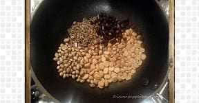 Dry roast coriander seeds, cumin seeds, peppercorns, toor dal, and Bengal gram for tomato rasam recipe.