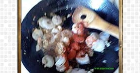 Spicy prawn getting stir fried with red chili powder.
