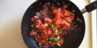 chopped tomato added to the pan.