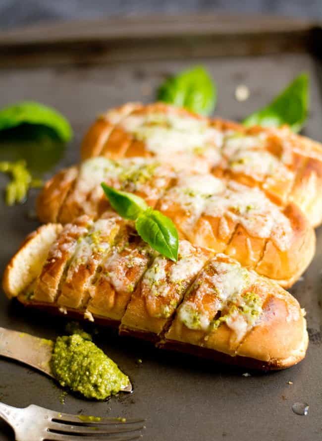 Pesto Garlic Bread recipe yields cheesy, soft bread loaded with Basil pesto and minced garlic. Hands down the easiest way of making bread, which is baked and can be made in minutes.