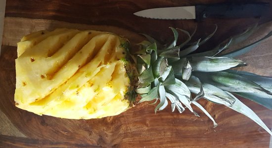 How to cut pineapple without waste is easy and explained with 5 simple steps along with small video. Simple directions with minimal waste.