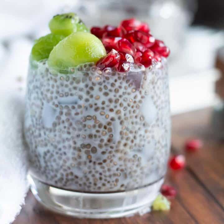 coconut milk chia pudding in a glass topped with fresh fruits