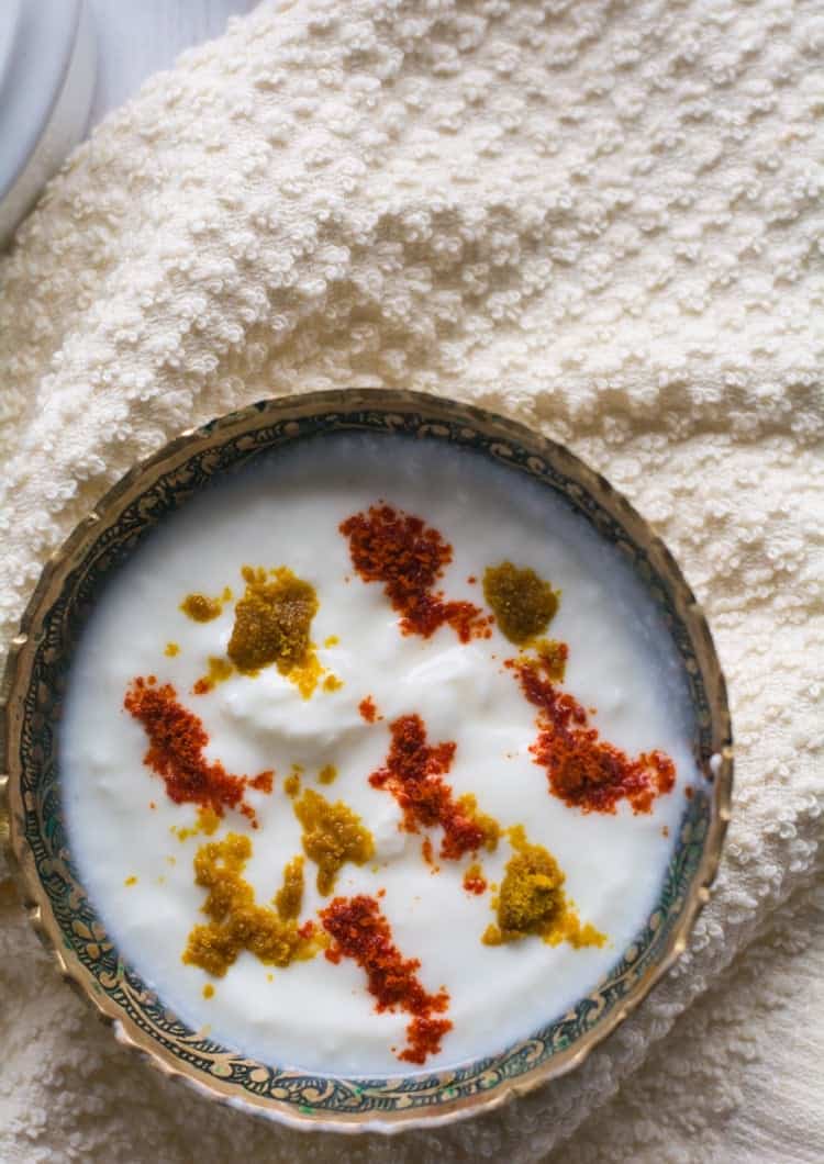 masala raita served in a rich golden bowl, garnished with the spice powders.