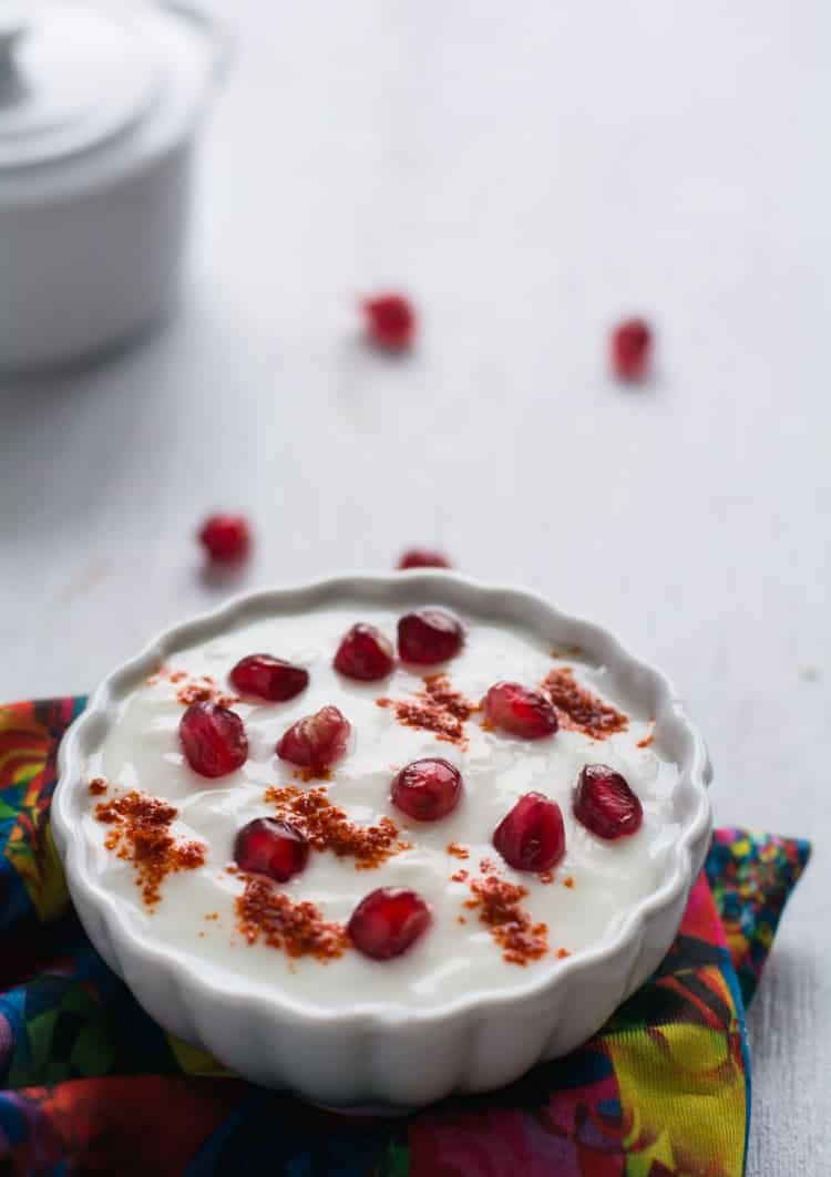 Pomegranate Raita made with yogurt / curd, fresh pomegranate arils and chili powder. This recipe is simple and quick to make. This raita tastes ultimately delicious and it is creamy, sweet and also spicy. Perfect to serve as side dish for rice or roti.