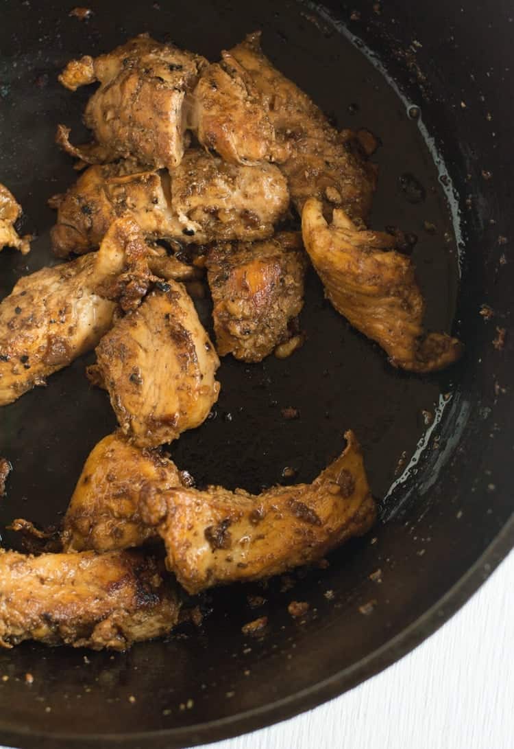 How to make spicy Szechuan chicken, Chicken breast cubes in the cast iron skillet.