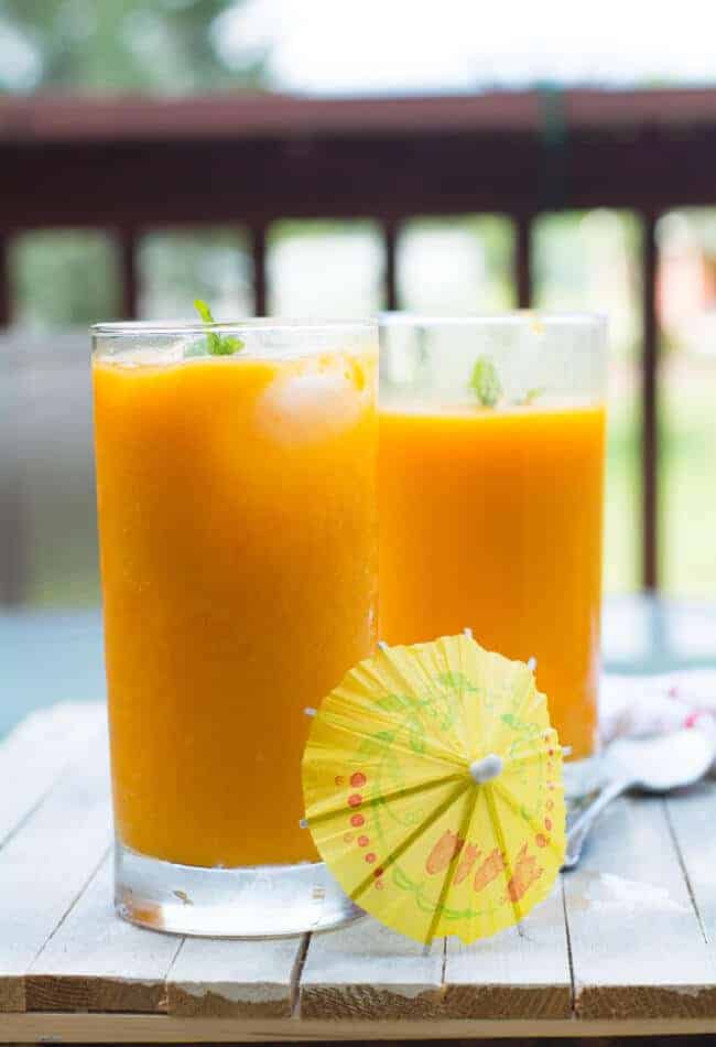 Healthy homemade mango juice made with mango pulp, sugar and ice cubes.