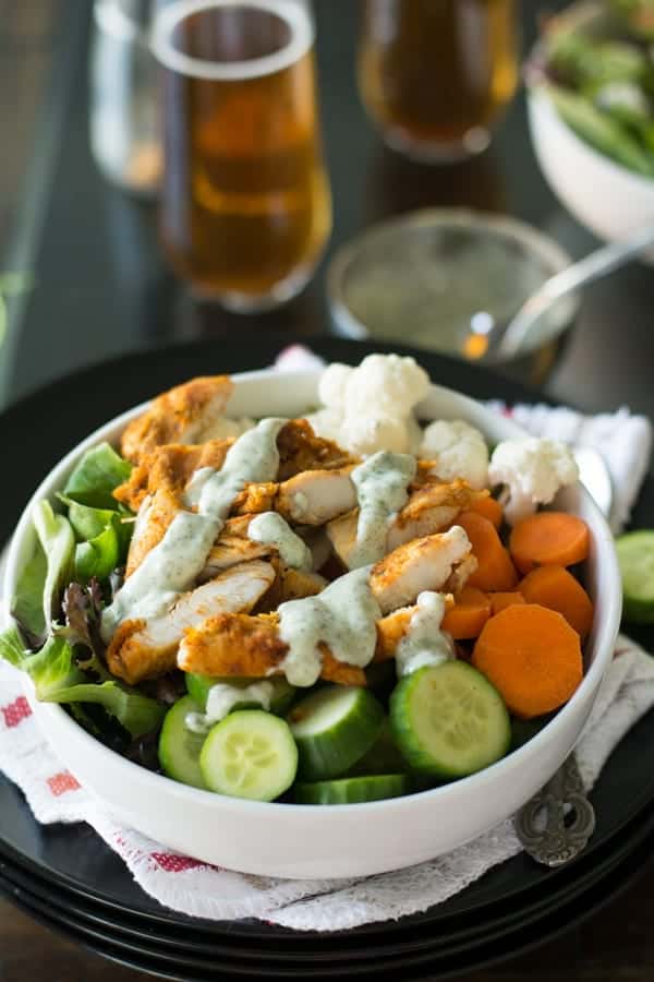 This Greek yogurt salad in the bowl with the healthy drinks on the background.