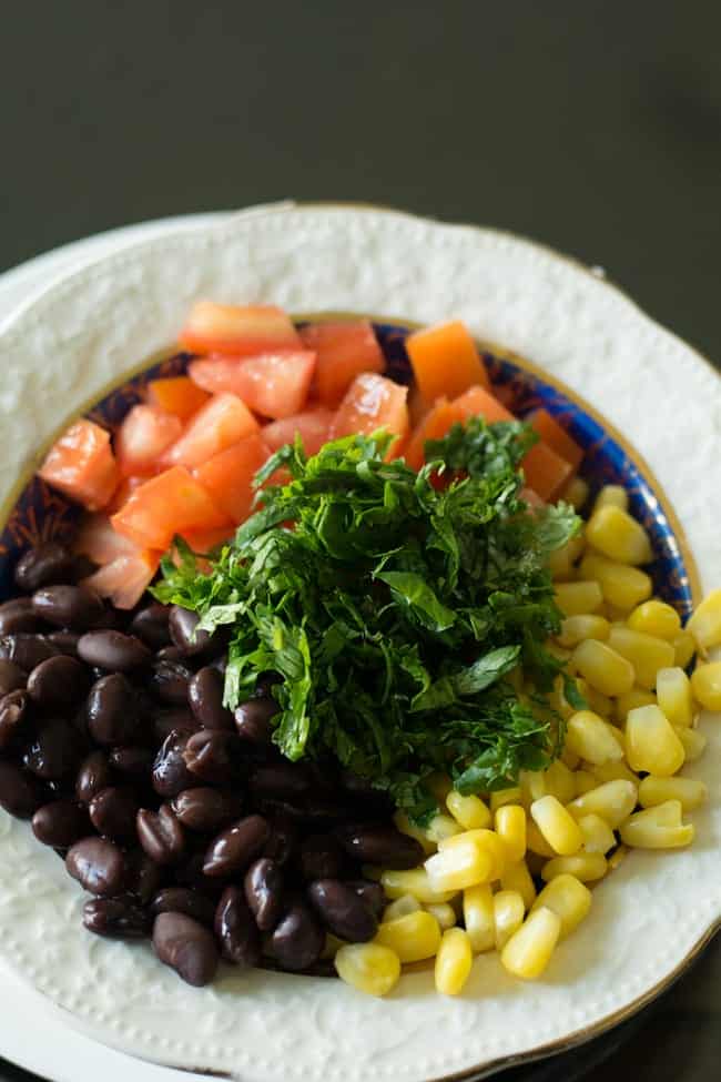 the key ingredients for this black bean corn avocado salad are the black bean, corn kernels, avocado, cilantro.