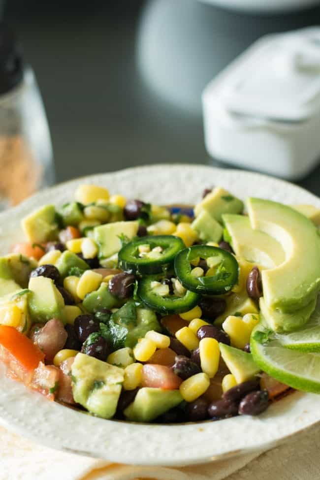What is the black bean corn avocado salad? This is a Mexican-inspired recipe, which is simple and straightforward. As the title by itself lets you know the ingredients, made with black bean, corn, avocado, jalapeno, lime, and cilantro.