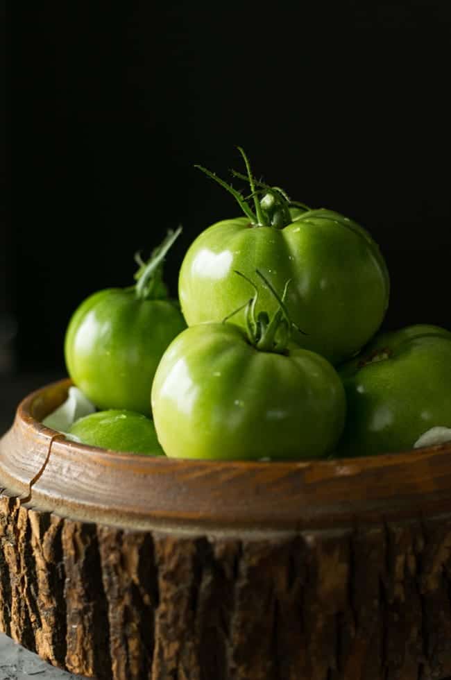 Getting garden fresh green tomatoes to make salsa verde from the back yard.