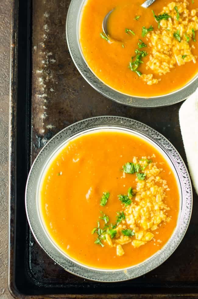 Roasted red pepper tomato soup served in a soup bowl