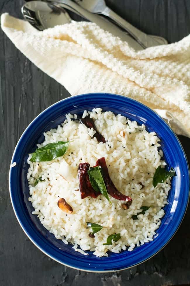 Indian Coconut Rice Recipe made with grated coconuts, cashews, and cooked rice. The recipe is so simple and straightforward which takes less than 5 minutes to make effortlessly. A best satisfying food for busy days or weeknight dinners. A very popular lunch box recipe in South India which is gluten free, dairy free, vegan and vegetarian recipe.