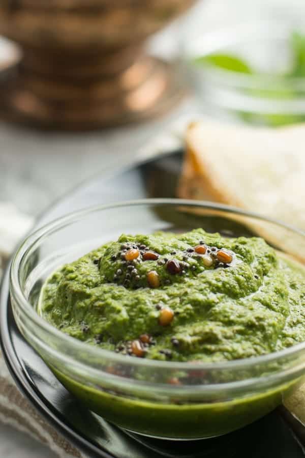creamy mint cilantro chutney is ready to serve as a side dish with the seasoning.