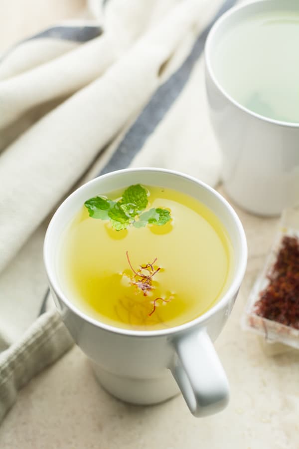 saffron tea served in a large glass.