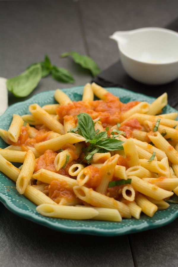 Penne Pomodoro pasta recipe made with 5 simple ingredients tomato, basil, olive oil, pasta and salt. A cozy comfort food, which is skinny and vegan. Very delicious food for the dinner.