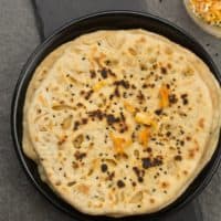 Onion kulcha recipe is one of the best homemade Indian bread recipes for dinner that you'll ever eat! Soft, fluffy, delicious, stuffed with onion and other spices. This onion kulcha is wholesome, and you will never realize that this kulcha bread is made actually with whole wheat flour and in tawa.