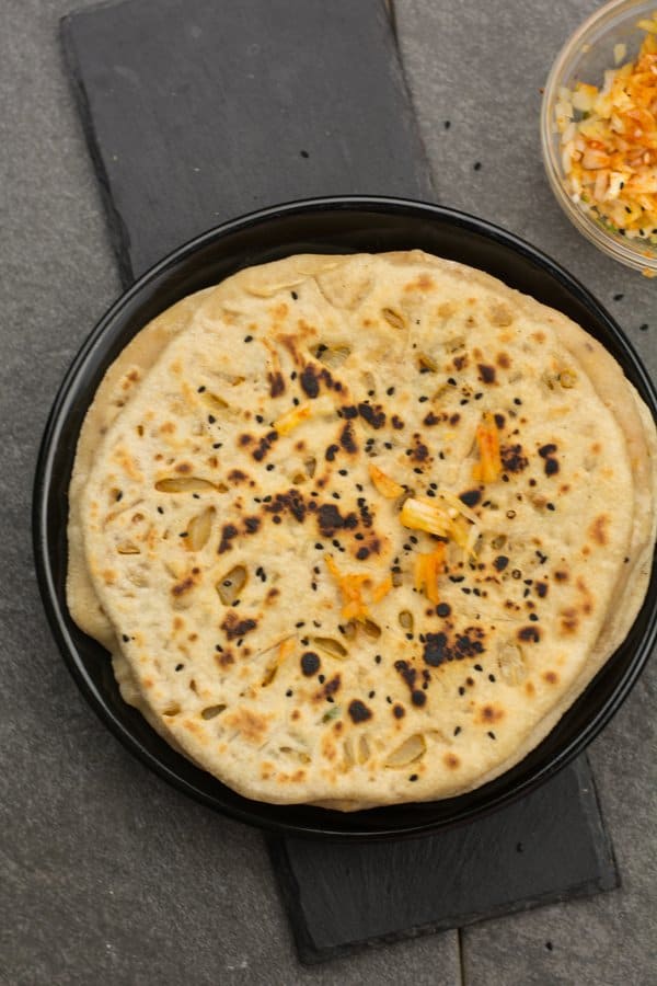 Onion kulcha recipe is one of the best homemade Indian bread recipes for dinner that you'll ever eat! Soft, fluffy, delicious, stuffed with onion and other spices. This onion kulcha is wholesome, and you will never realize that this kulcha bread is made actually with whole wheat flour and in tawa.