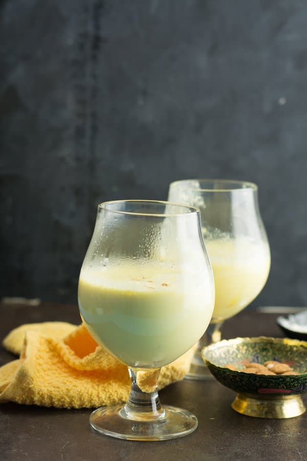 traditional drink recipe of India-Badam milk. This almond milkshake is made with milk, almonds, cardamom, saffron strands, and sugar