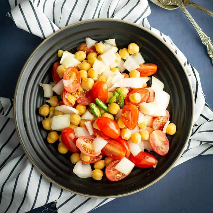 Indian tomato salad is loaded with tomatoes, onion, vegan protein chickpea. Means, a light, easy, filling dinner for your busy weeknight.