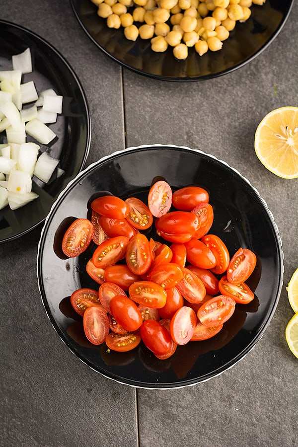 Any type of tomato is good to make this Indian summer salad. Including cherry, roma, or plum tomato. Start preparing the salad by chopping vegetables roughly.