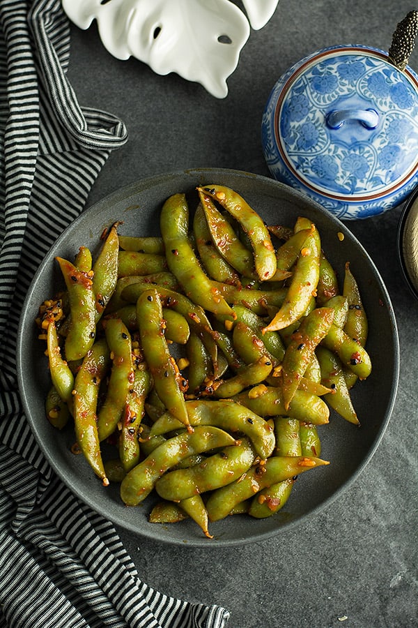 This spicy garlic edamame is ready like a flash perfect for your spicy cravings. Made with frozen edamame, garlic, and chili sauce.
