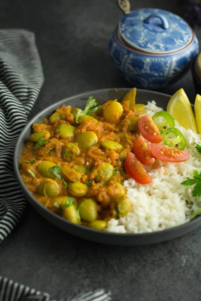 lima bean curry served with a bed of rice