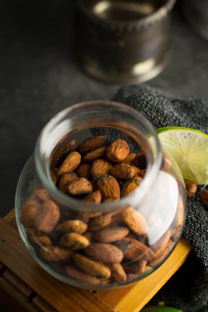 the chili and lime coated almonds in the clear jar with top view.