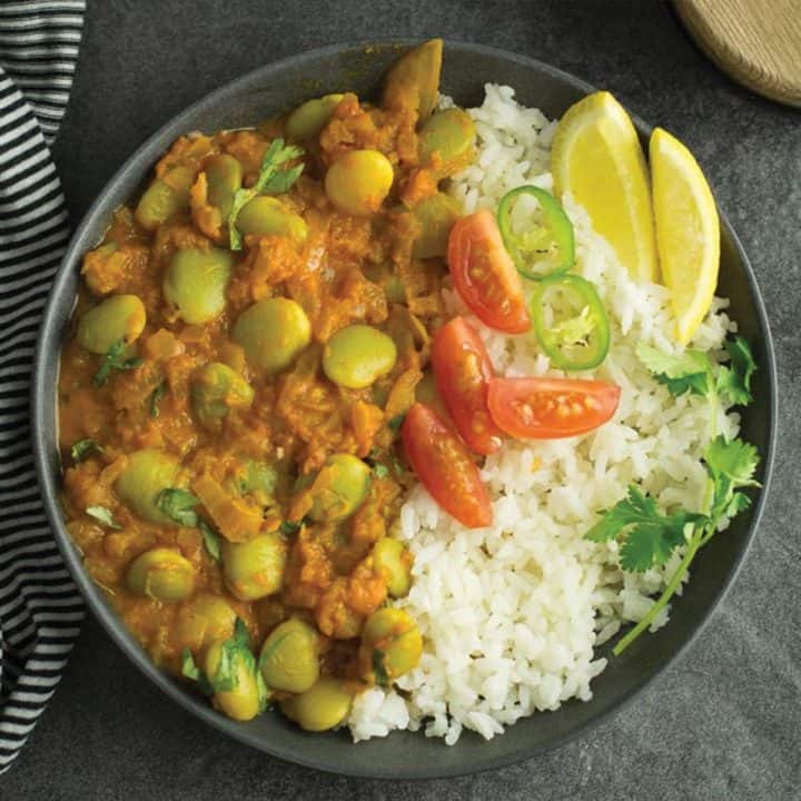 lima bean curry served over bed of rice.