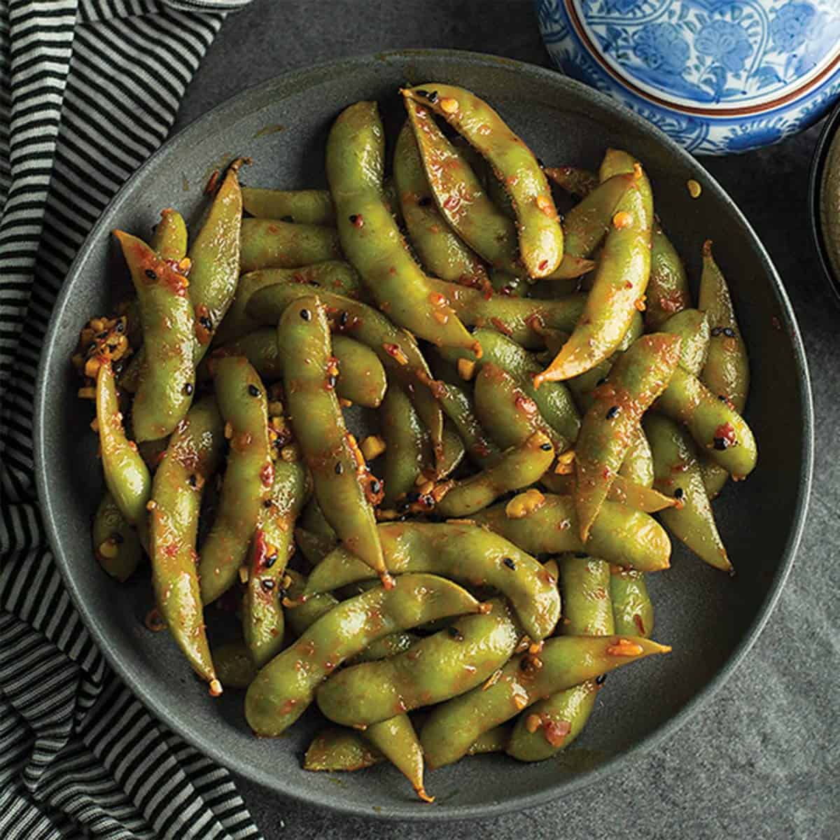 spicy garlic edamame is ready like a flash perfect for your spicy cravings. Made with frozen edamame, garlic, and chili sauce.