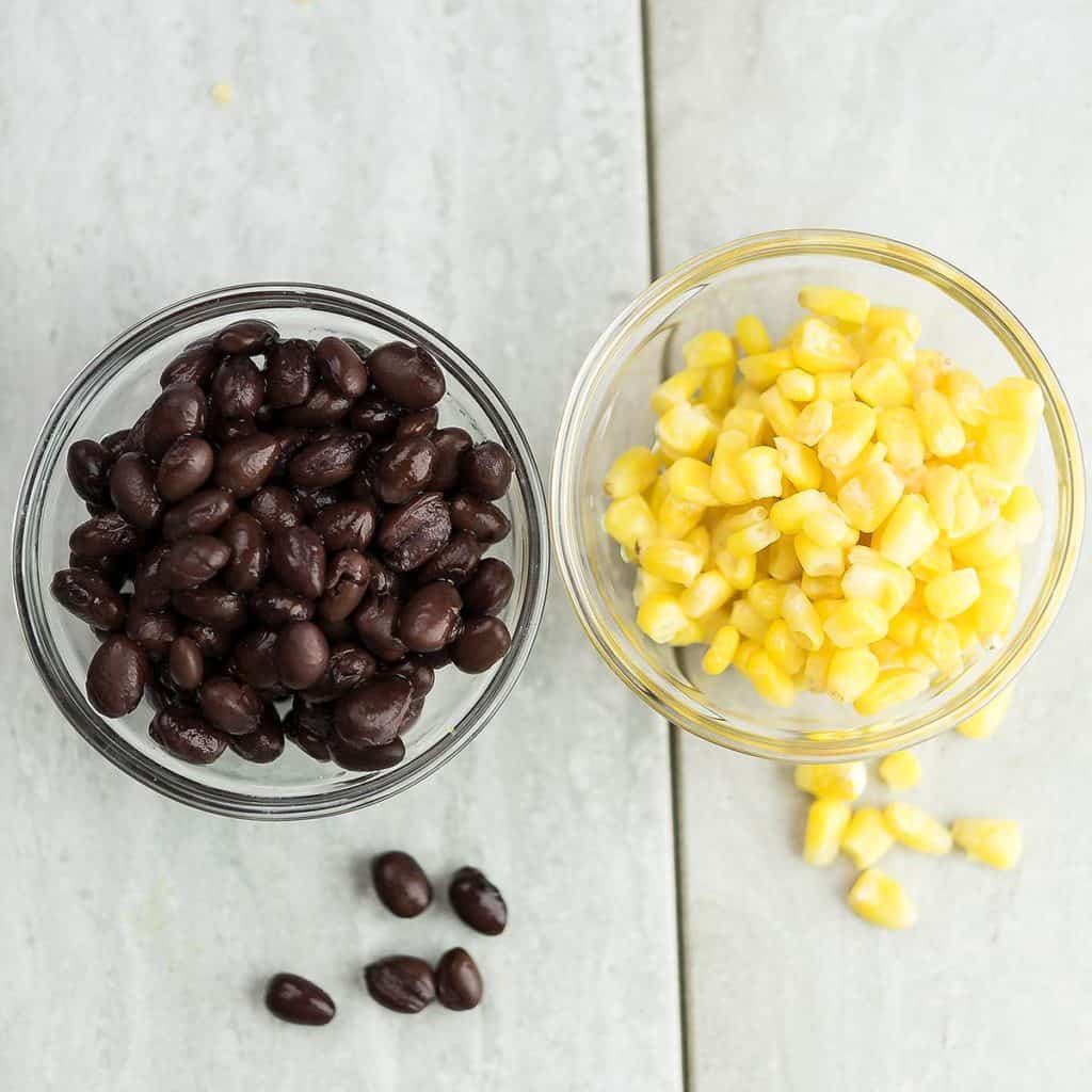 black bean and corn kernels kept in a glass bowl for fiesta taco salad.