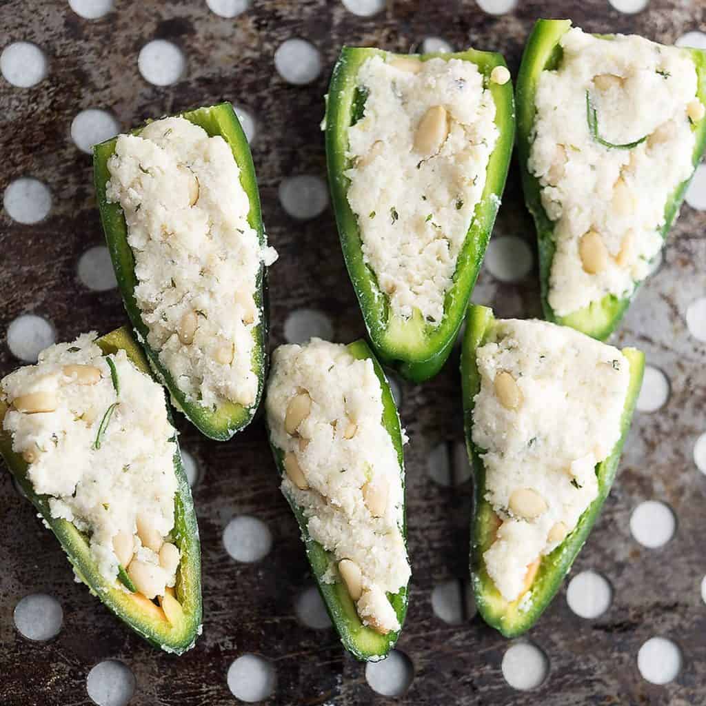 Jalapenos are stuffed with vegan almond cream cheese and ready to make poppers.