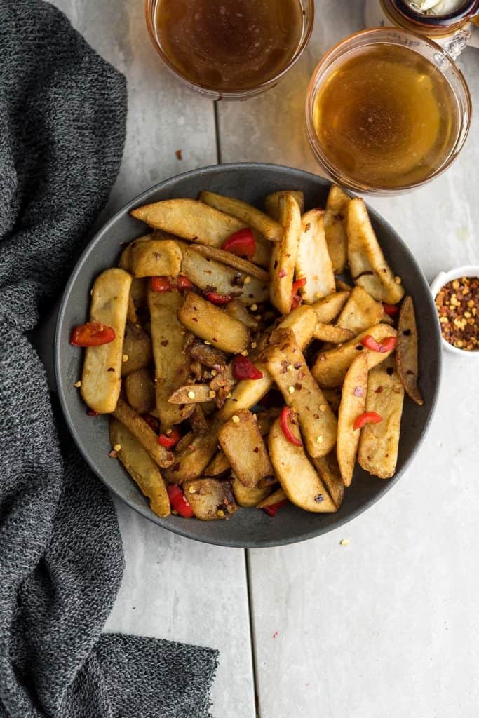 Chinese French fries served in a black bowl as appetizer.