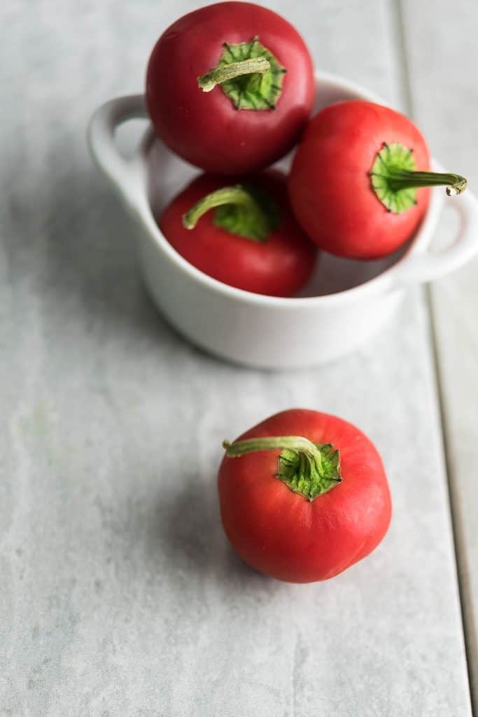 Pimento (cherry  peppers) placed in a white bowl.