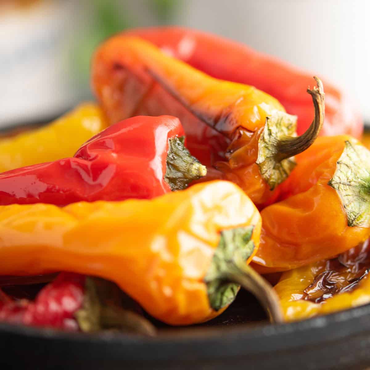 oven roasted mini peppers served in a plate with balsamic glaze