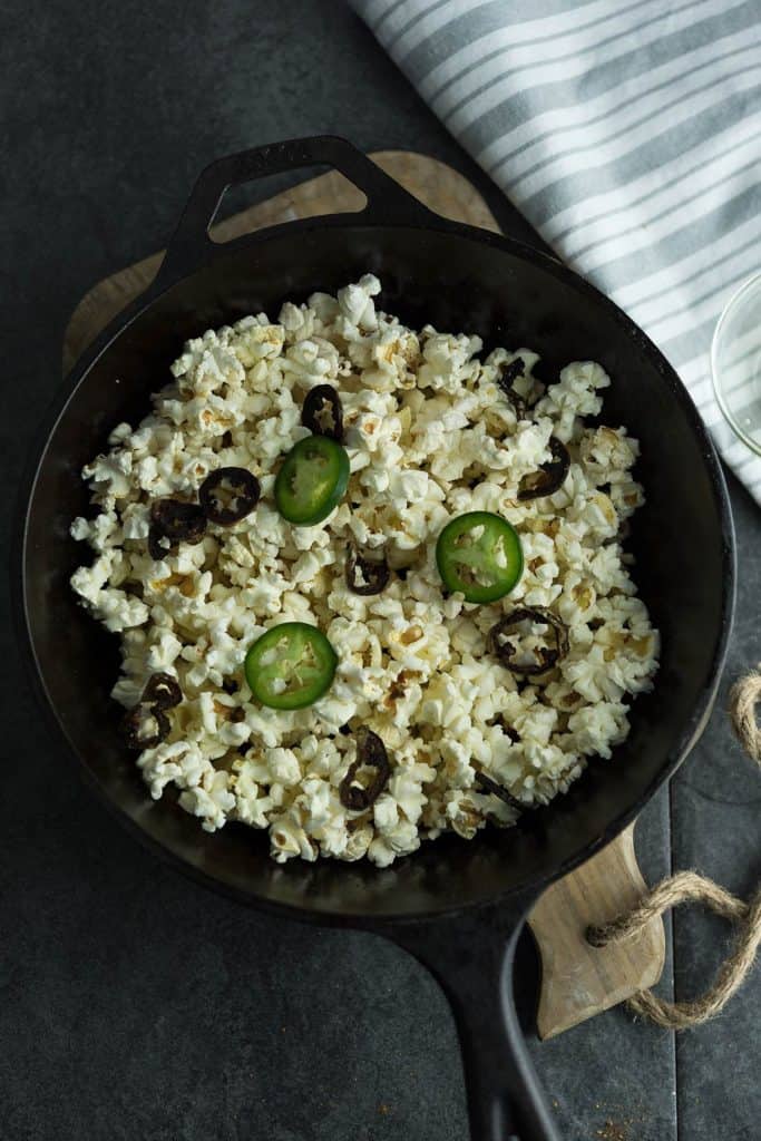 This spiced jalapeno popcorn is flavorful, mildly spicy placed over a pan.