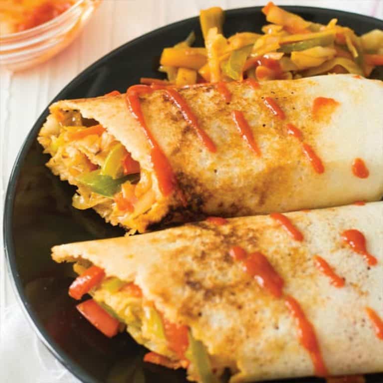 spring dosa served in a black plate