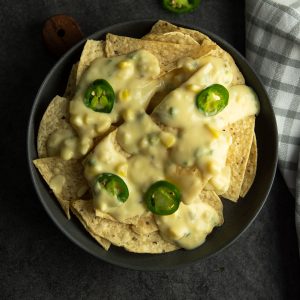 Spicy jalapeno nachos served with creamy cheese sauce.