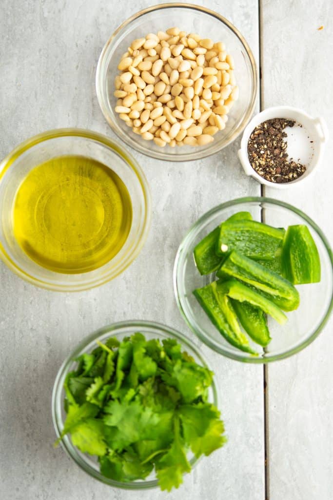 ingredients of jalapeno pesto kept in individual cups