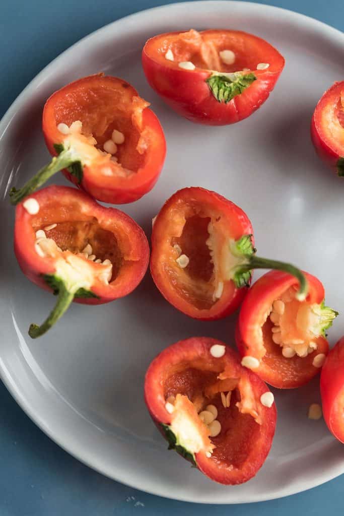 cherry peppers are scooped out for the stuffing.