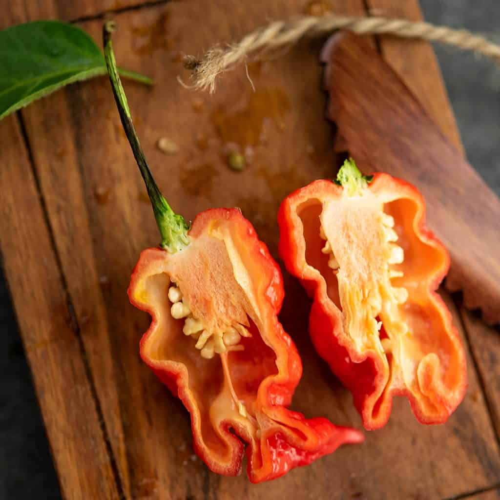 Ghost pepper cut into half with seeds.