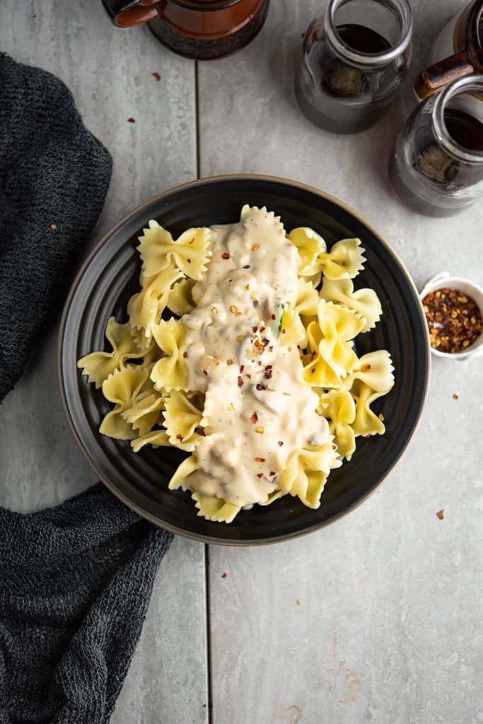 Spicy alfredo sauce over pasta served for weeknight dinner.