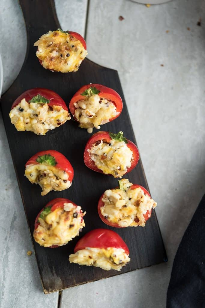 cherry peppers are placed in a wooden plate for serving.