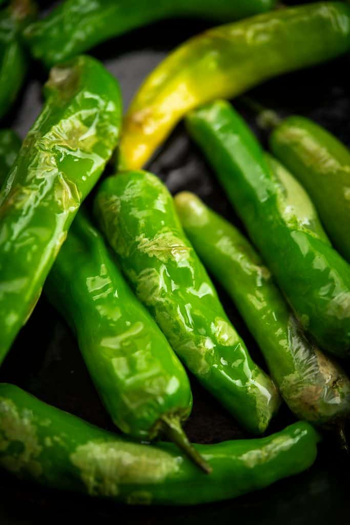 The closeup shots of blistered Shishito peppers.