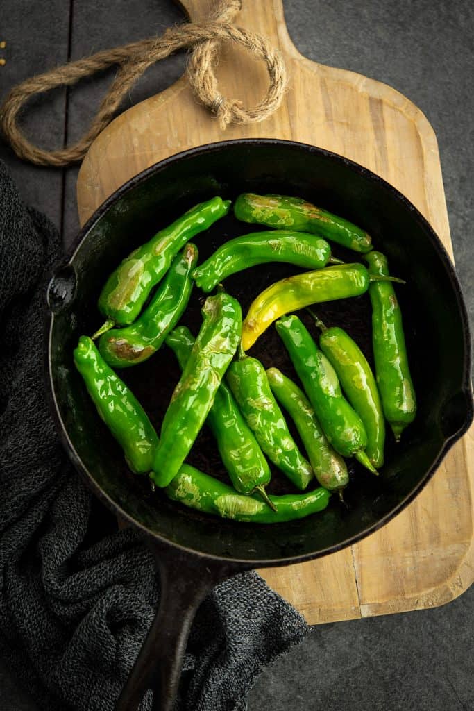 Oven roasted Shishito peppers are perfectly blistered in the pan