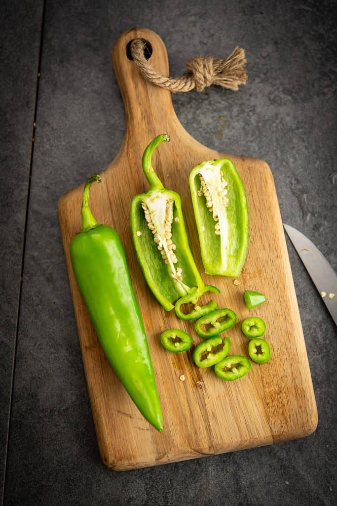 Anaheim pepper cut and placed in a cutting board