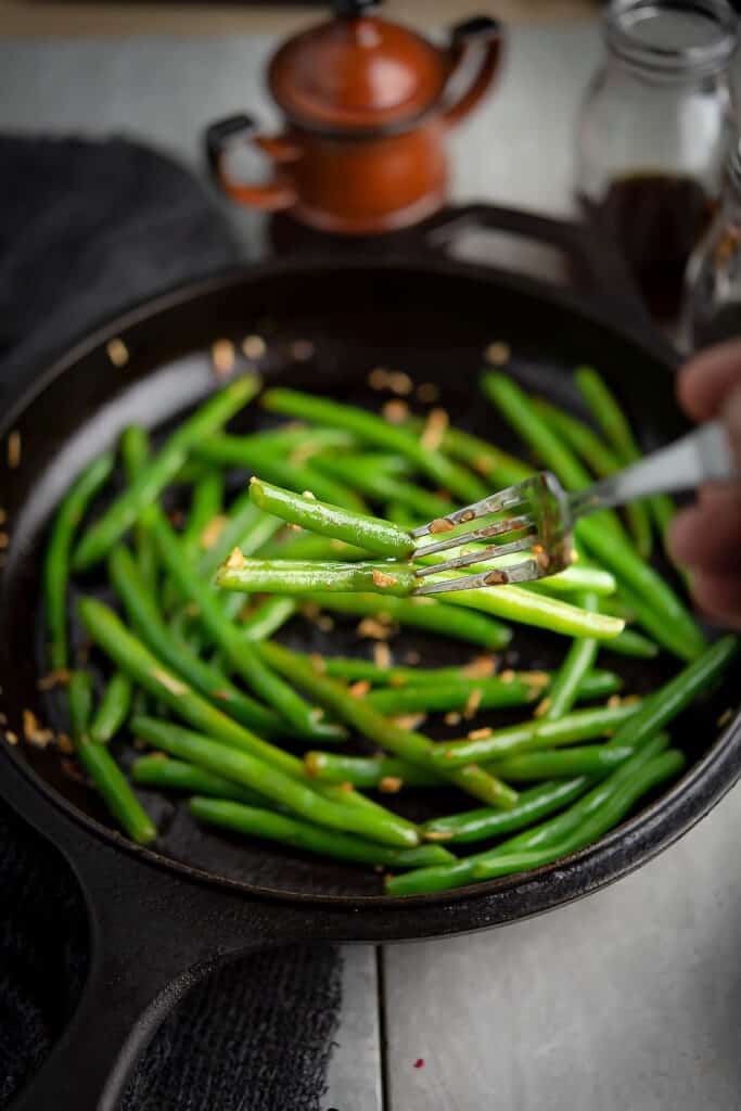 Fork tender green beans nicely coated with spices.