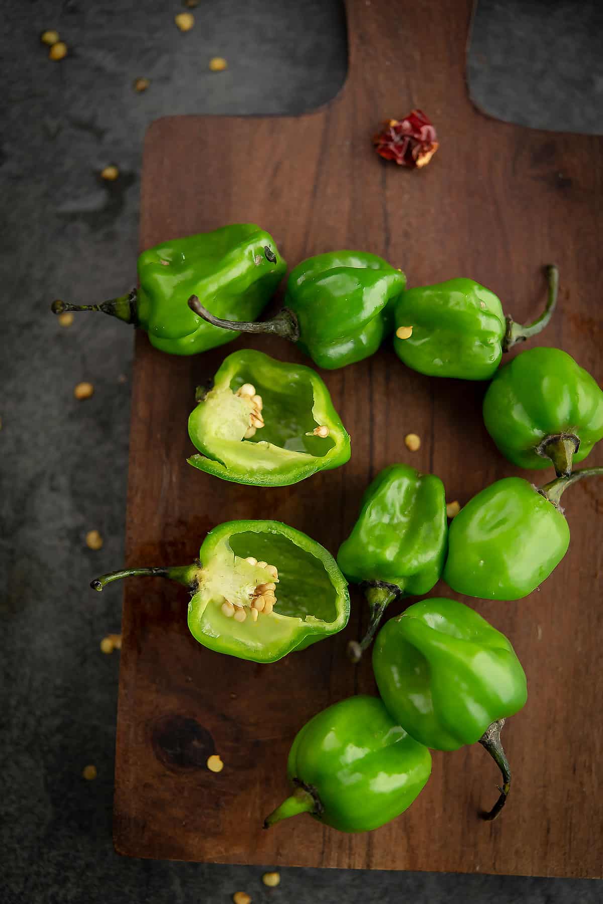 scotch bonnet peppers placed in a wooden board