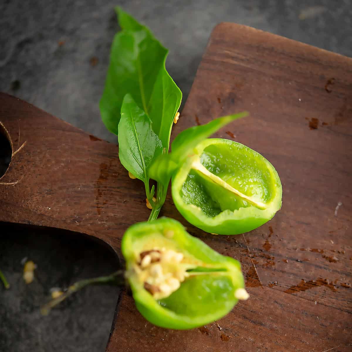 cross section of the scotch bonnet chili pepper placed in a chopping board