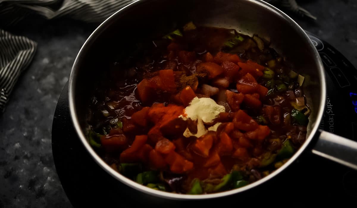 adding the spices in the tomato sauce